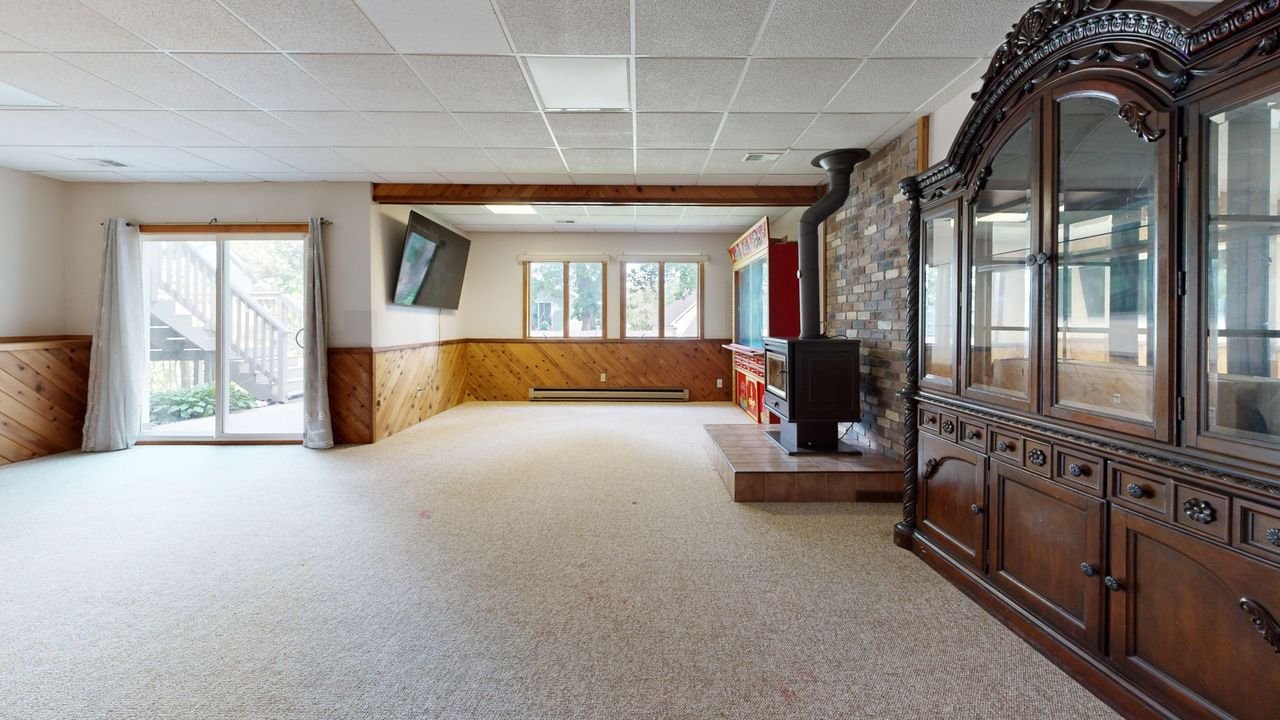Mastering the First Impression: Your intriguing post title goes here Cozy basement with wooden paneling, fireplace, and sunny windows. Great for relaxation.