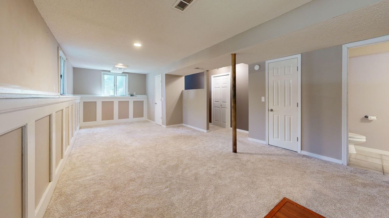 The Art of Drawing Readers In: Your attractive post title goes here Bright and clean modern basement with carpet flooring and recessed lighting.